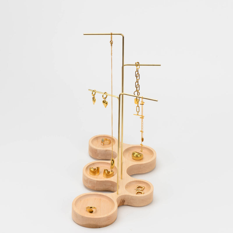 Sideview picture of ultra modern maple wood based and brass bar jewelry stand